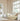 Children's bedroom with white bed, bookshelf, and toys.