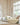 Children's bedroom with white bed, bookshelf, and toys.
