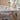 Child using a height-adjustable desk with a window in the background