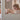 Child sitting on a bed with stuffed animals in a cozy bedroom