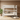White bunk bed in a room with a plant and rug