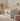 Children's bedroom with a white bed, pink ottoman, and desk.