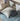 Children's bed with blue bedding and patterned pillow, wooden shelf in the background