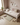 Children's bedroom with a bed, toys, and a plant on a wooden floor.