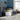 Children's bedroom with blue walls, white furniture, and toys.